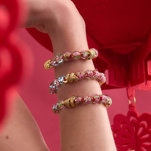 Golden Snake Firework Glass Rose Bracelets with red and pink handblown beads and 18k gold plated snake charms on wrist by NOGU